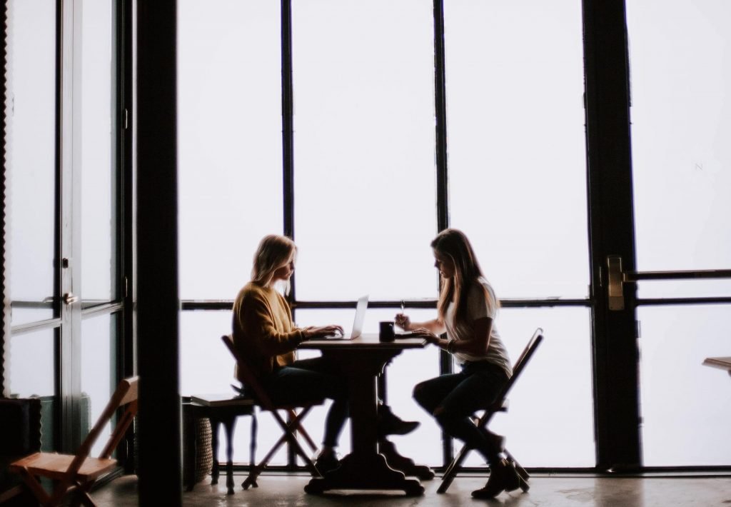 Two people talking at a table about opportunities to thrive